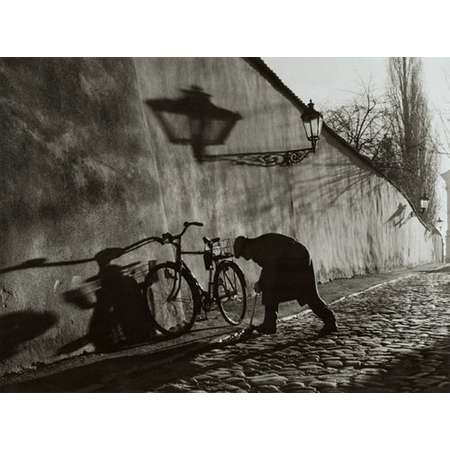 Untitled (Man Repairing Bicycle Tire)